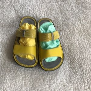 Canary yellow Alegria slides.